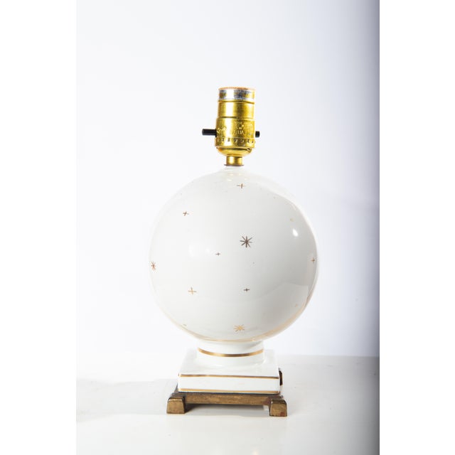 Small European white ceramic table lamp with celestial stars. Shade is included. 10.5" to top of socket. 6" diameter shade.