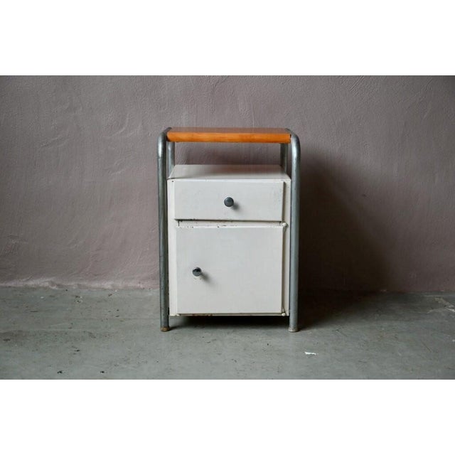 with its distinctly industrial look, this 1950s boarding school bedside table has a strong personality! Featuring tubular...