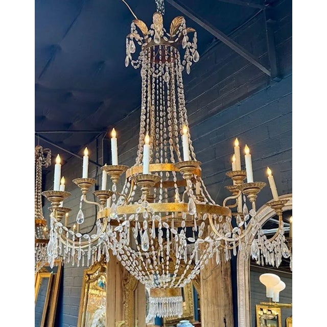 The Antique Large Scale Tuscan Gilt Bronze and Crystal Chandelier exudes a sense of grandeur and sophistication with its...