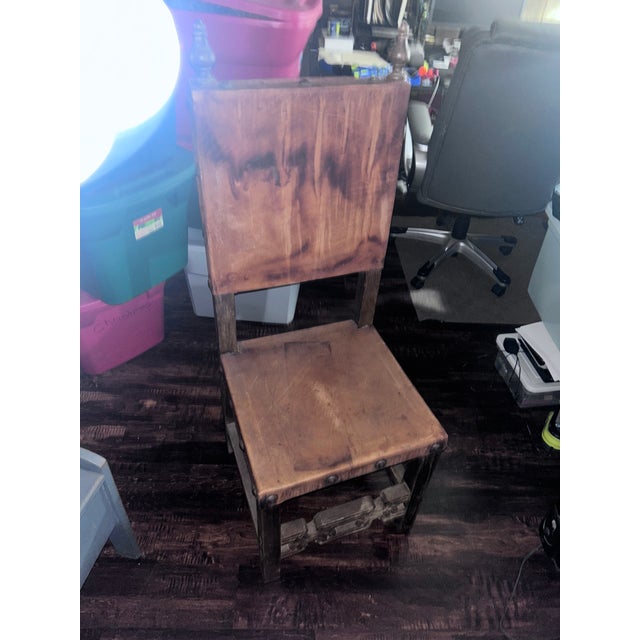 Handcrafted Mexican chair stamped "Artes de Mexico". Solid oakwood frame with original leather seat and back. Decorative...