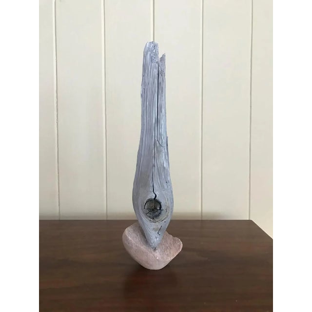 This piece was inspired by the natural dialogue between erosion, time, and resilience. The weathered wood—its grain split...