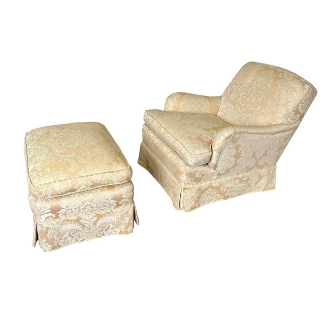 Antique upholstered rolled arm chair and ottoman Upholstered in a gold beige damask fabric. A very cozy relaxed chair that...