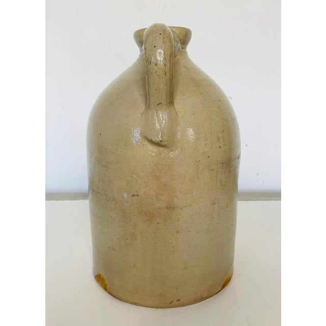 Antique stoneware tall 2 gallon handled jug by New York Stoneware Co. Beautiful brown glaze inside and comes with a spout....