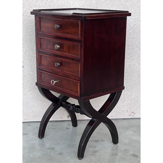 A pair of Antique French Louis XV mahogany nightstands. Subtle contours and scroll shapes are evident in the corner posts...