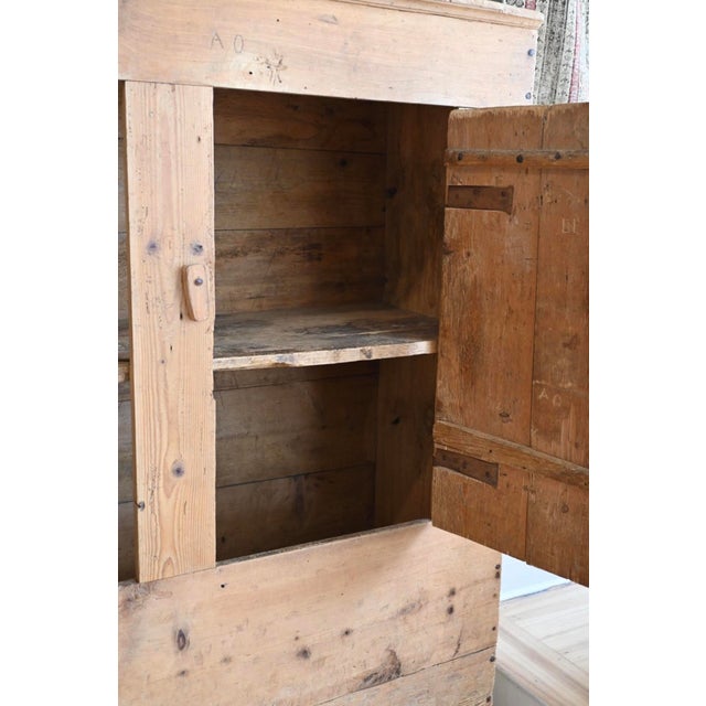 Lowkey cool and clean lines with this large antique French cabinet in solid pinewood. Primitive with a plank wood frame,...