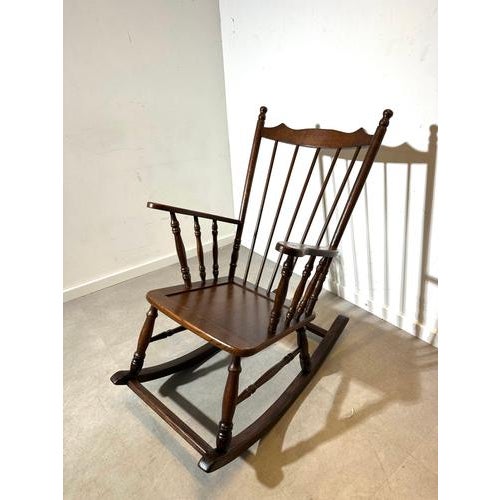 Beautiful vintage Windsor rocking chair with a timeless spindle-back design and turned wood details. Finished in a warm...