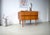 This is a teak chest of drawers from the 1960s. The design is characterized by clean, minimalist lines. The cabinet has...
