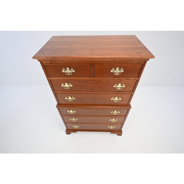 A classic cherry highboy dresser by L. & J.G. Stickley, made in 1991, designed with a traditional two-part form and well-...