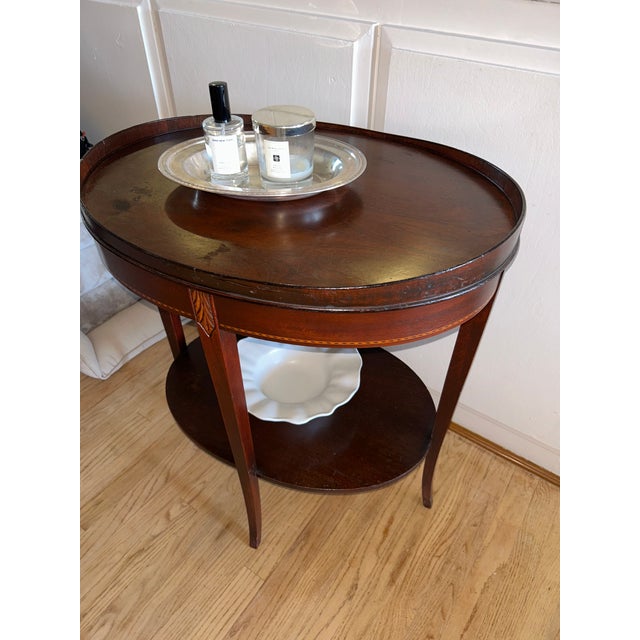 Elegant vintage two-tier side table by Mersman, crafted in a rich mahogany finish with classic Federal-style details. The...