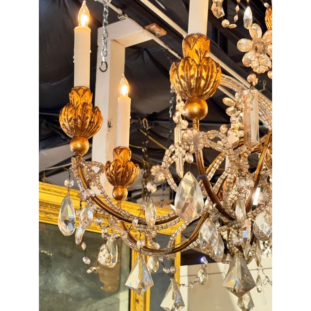 The 19th century Italian giltwood and crystal chandelier is a stunning and elegant lighting fixture perfect for any dining...