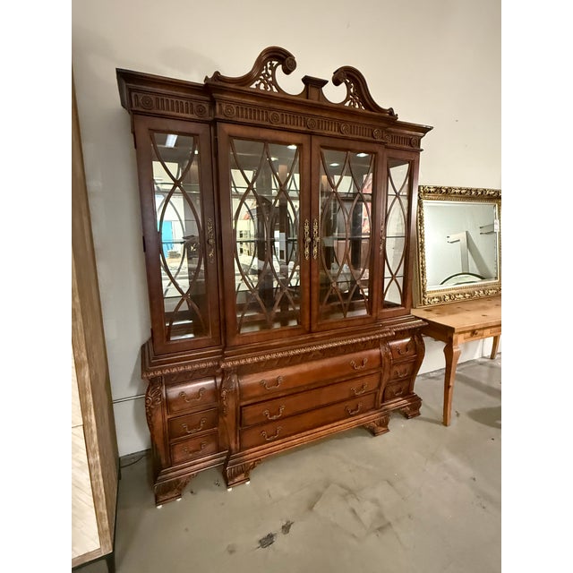 Design Plus Gallery presents a Federal Style Carved Mahogany Lighted Breakfront China Cabinet. Made from solid woods and...