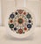 A Pietra Dura white marble decorative plate with inlaid semi-precious stones. Skillfully handcrafted in a floral motif....