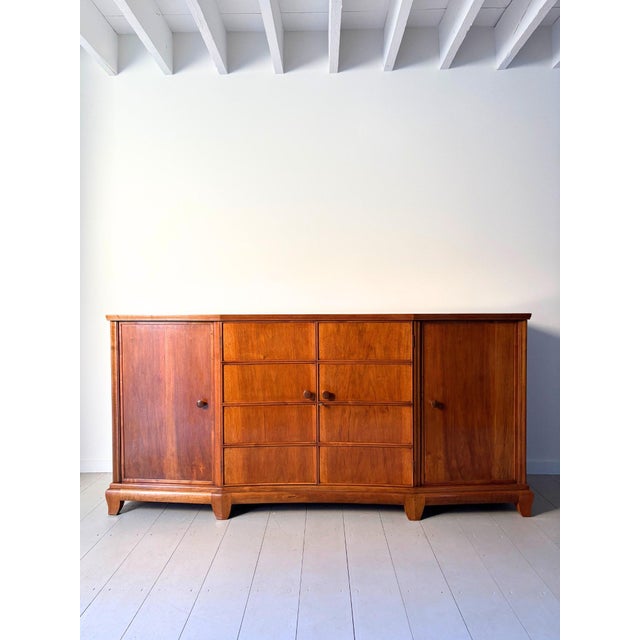 A 1930s sideboard or buffet, handmade in walnut. This italian credenza displays a rarified simplicity with subtle art...