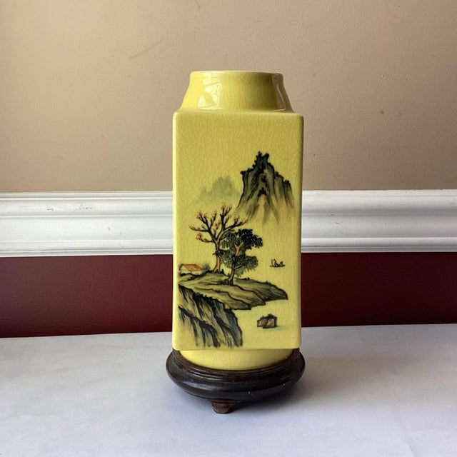 A serene and finely crafted Chinese porcelain vase, glazed in a soft yellow tone and adorned with a hand-painted landscape...