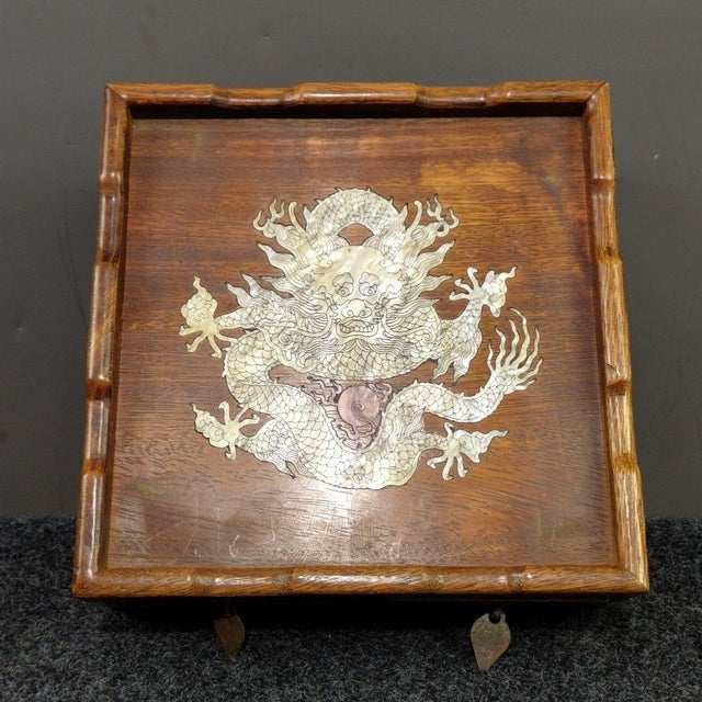 This charming Chinese rosewood multi‑purpose box features a striking mother‑of‑pearl inlaid dragon motif across the top....