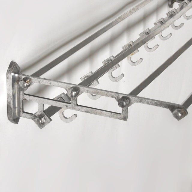 Wall coat rack in art deco style from the 1950s, made of iron and aluminium and equipped with 8 sliding hooks on a square...