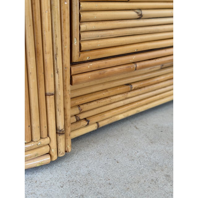 Stunning vintage pencil reed rattan chest featuring a sculptural arched design across the drawer fronts with beautifully...