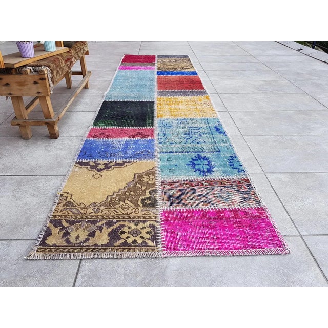 This is a vintage Turkish Oushak rug from the Mid 20th Century. The piece was hand-knotted.