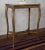 Elegant antique side table made of solid beech wood with the original gilded finish. The slender curved legs are decorated...