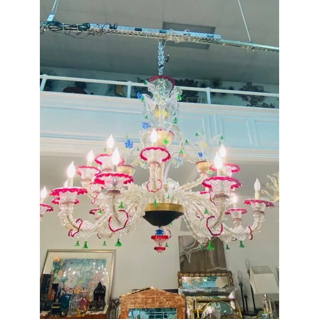 Monumental Clear and Multi Colored Elaborate Murano Glass Chandelier with 18 Arms with Candelabra Bulb Fixtures.The Murano...