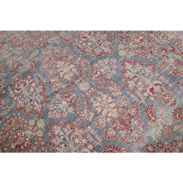 An early 20th century Persian sarouk in blue , red and pink 8'10'' x 11'5'' .