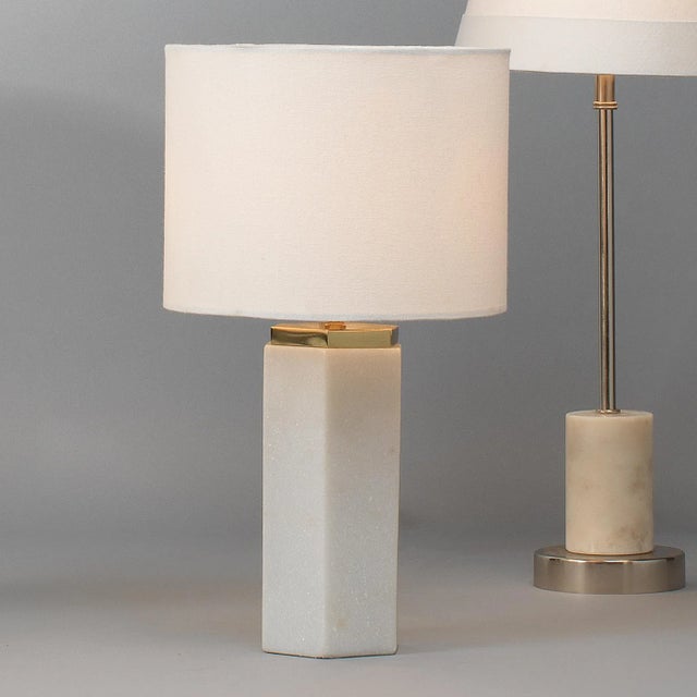 Introduce a timeless touch to your interiors with this accent table lamp. The simple geometric form is hand-carved of...