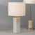 Introduce a timeless touch to your interiors with this accent table lamp. The simple geometric form is hand-carved of...