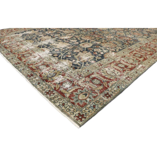 Distressed Antique Persian Tabriz Rug with Rustic Old World English Style 08'10 x 11'03. Cleverly composed and...