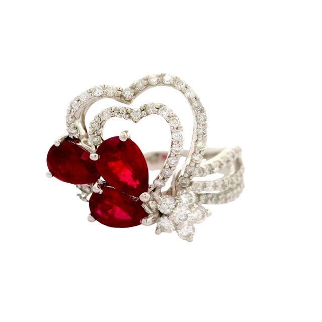 A striking fashion ring crafted in 18k white gold. It features three pear rubies, weighing a total of 2.13 carats, with a...