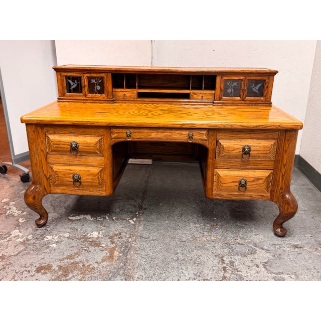 Design Plus Gallery presents a Vintage Oak Executive Desk. This desk showcases oak construction with a golden-toned...