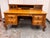 Design Plus Gallery presents a Vintage Oak Executive Desk. This desk showcases oak construction with a golden-toned...