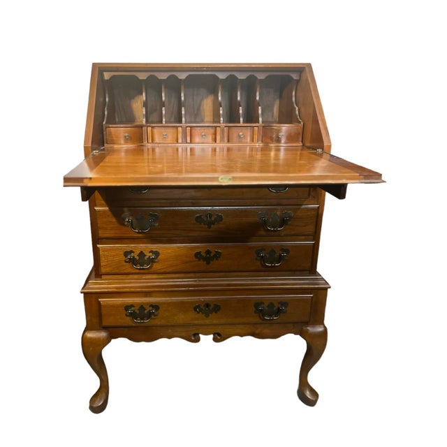 A vintage Maddox Colonial Williamsburg secretary, circa 1975, presents a charming petite design in cherry wood. This...