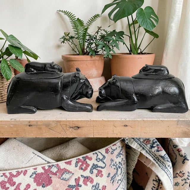 Elevate your home decor with these African Hippopotamus Folk Art Carved Black Solid Wood Figurines, designed as lidded...