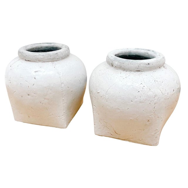 Striking pair of heavy, sculptural glazed clay urns. A great balance between rustic flair and modern minimalism, these...