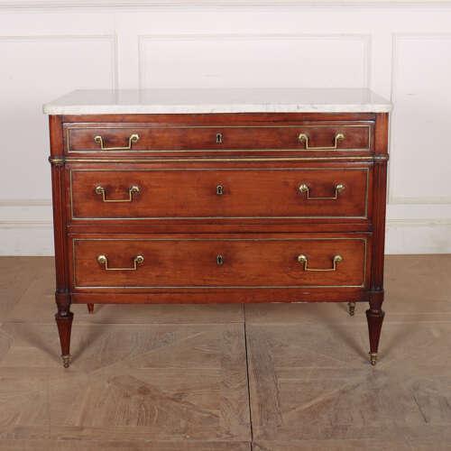 Early 19th Century French fruitwood 3 drawer commode with a thick marble top. 1820 This piece is designed in the style of...