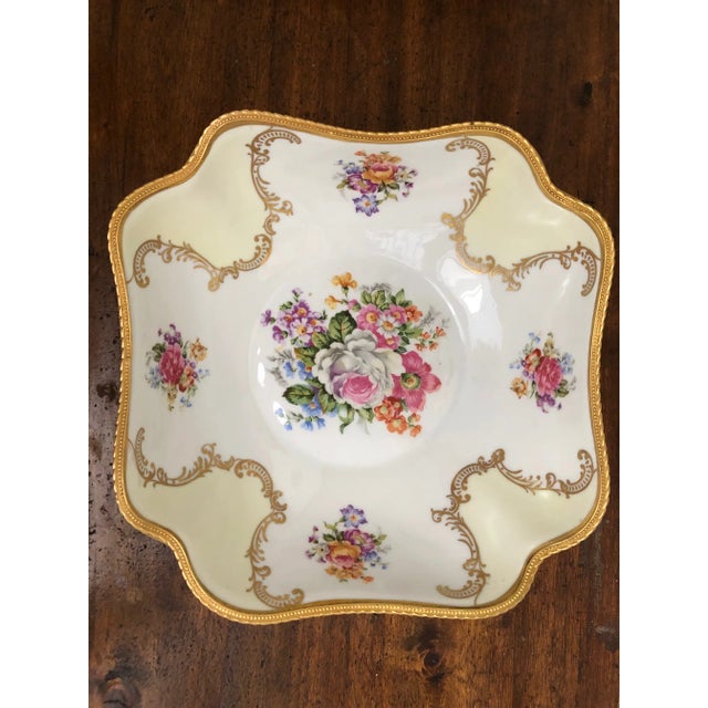 Beautiful hand painted porcelain bowl with bronze edging and feet. Vibrant wildflowers are framed by decorative gold...