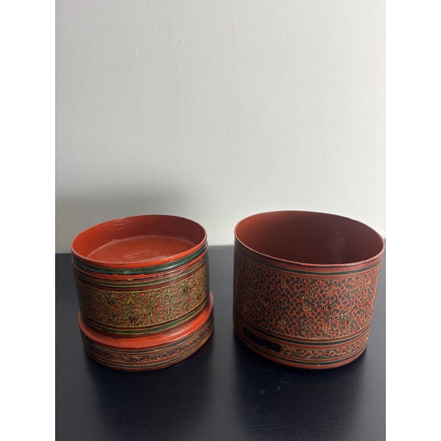 A striking set of antique Burmese lacquerware nesting boxes, hand decorated in the traditional yun technique. Rich...