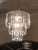 Fabulous set of Mid-Century chandeliers. with clear lucite prisms. The larger chandelier is three tiers and 10 lights. The...