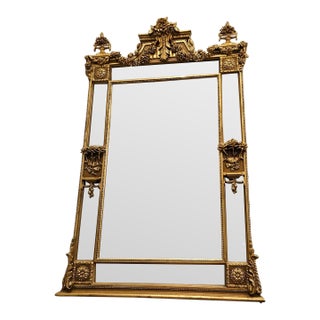 Grand French Louis XVI Gilded Wall Mirror With Floral Crest & Beveled Mirror Panels For Sale