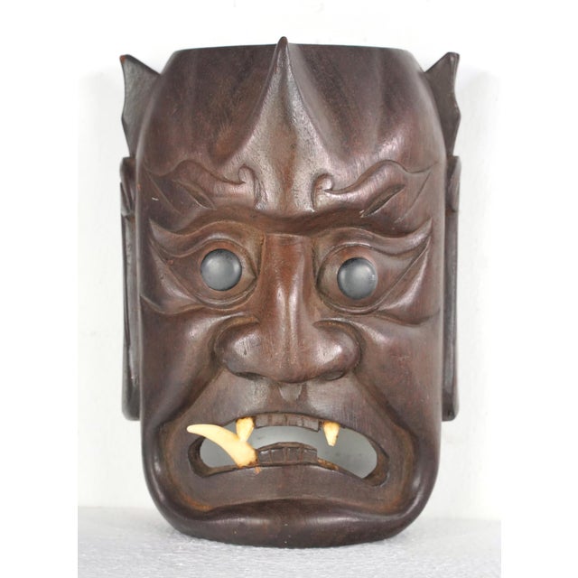 These are vintage Japanese hand carved wooden masks, commonly identified as Oni or Noh demon masks. They represent various...