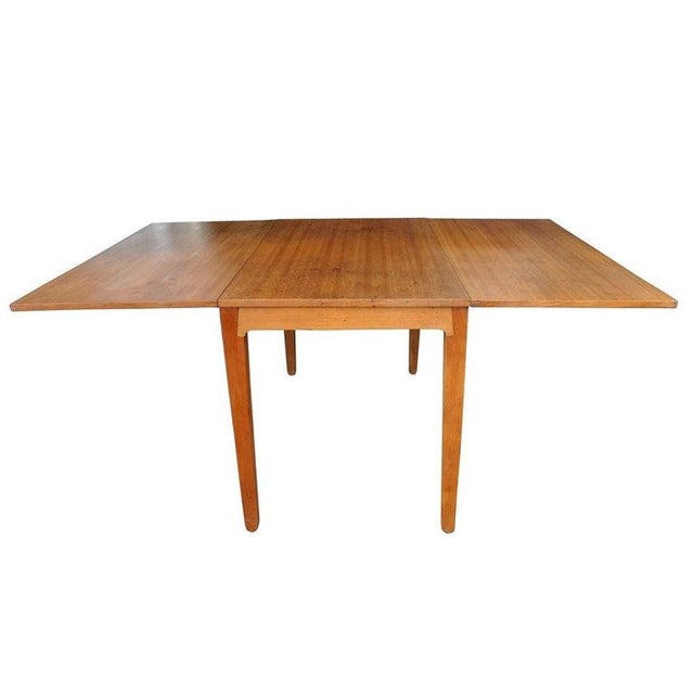 A Mid-Century Modern dining table designed by Edward Wormley for Drexel's Precedent collection. The drop leaf table...