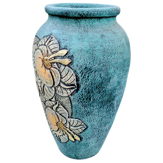 A large textured urn shaped vessel/vase. The terracotta pottery has a basecoat of black paint with a textured...