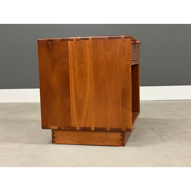 A mid century modern solid cherry single drawer nightstand with exposed dovetail construction. Made in USA. Circa 1980’s....