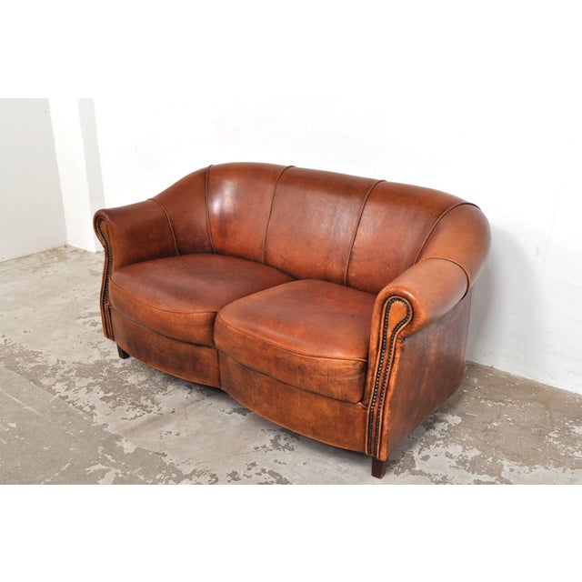 Beautiful sofa from the dutch brand joris in art deco style. The seat cushions are fixed in this model. The sheepskin...