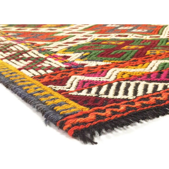This Vintage Turkish Kilim, measuring 2'10" by 4'4", is handwoven with wool on a wool foundation in Turkey’s Oushak...