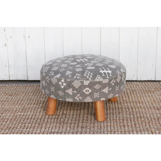 This versatile pair of round dhurrie ottomans, features a stunning cotton cover adorned with an African mudcloth style...