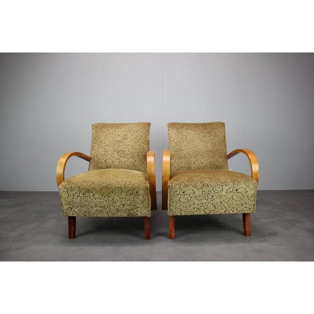 Elegant pair of original 1950s armchairs by Jindřich Halabala, originating from Czechoslovakia. The chairs feature...