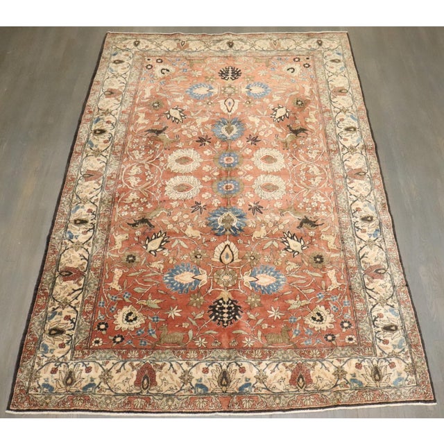 An early 20th Century Persian Teheran Hunting Animal scene rug in predominantly brown