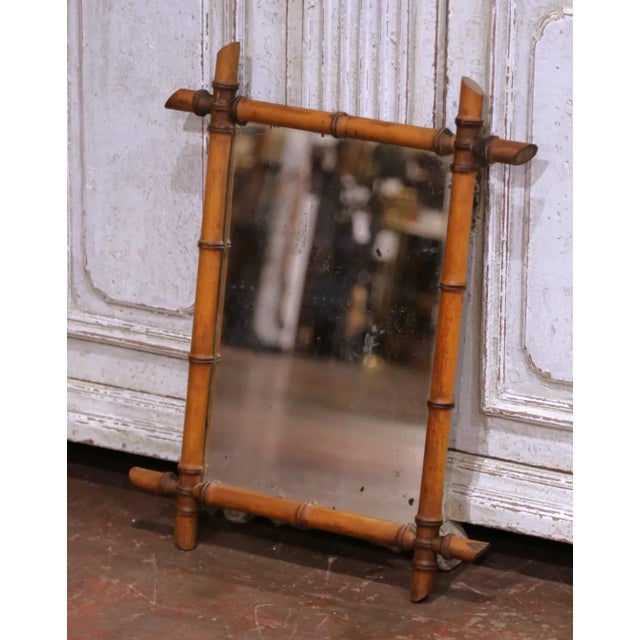 Decorate a hall way or powder room with this charming antique spindle-turned wooden mirror. Crafted in France circa 1920,...