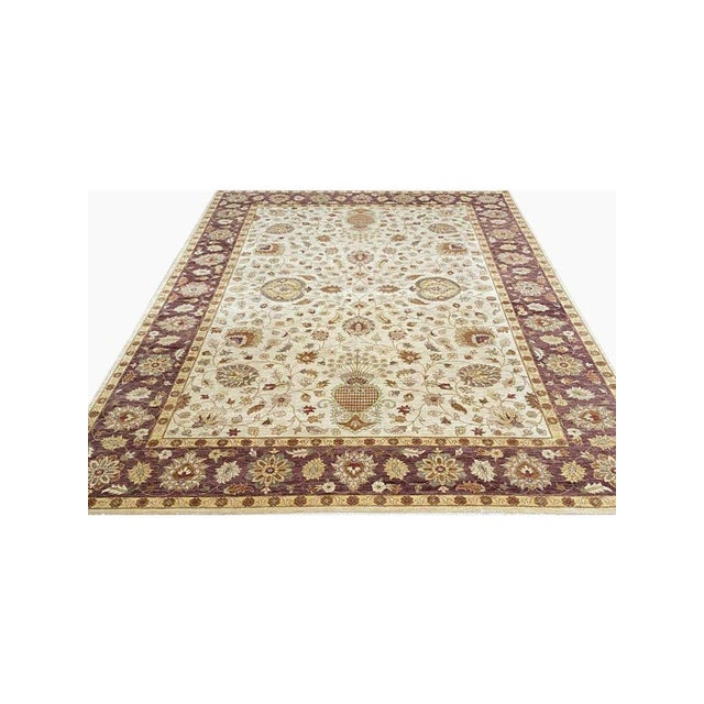 Upgrade your space with the timeless beauty of this 10x14 handwoven Indian Agra Area Rug. This exquisite rug features a...